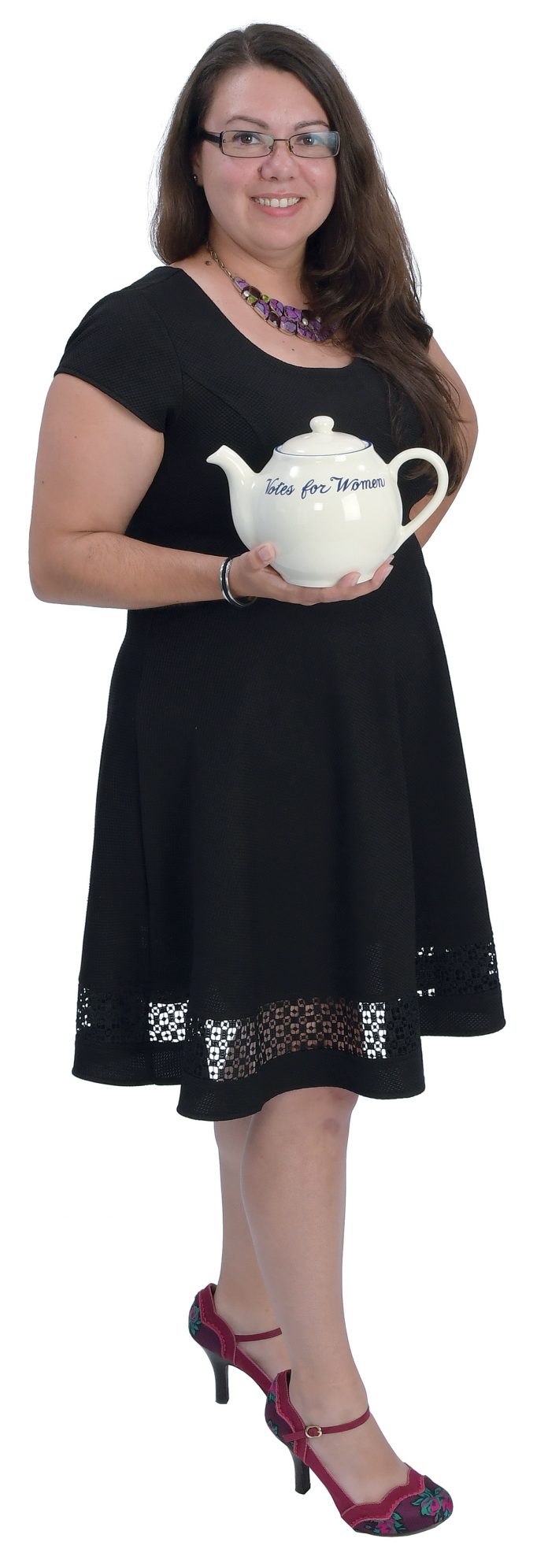 the prop: A “Votes for Women” teapot. The item is sold at the Newport Mansions and on Newportstyle.net. It’s the item that built The Preservation Society’s wholesale line. It represents her work with the PSNC.  / PBN PHOTO/MIKE SKORSKI