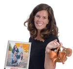 the prop: Elizabeth Catucci holds a family portrait and her new dancing shoes: “Being a working mom, I think it’s great that my girls get to see that. I just took up ballroom dancing.”  / PBN PHOTO/MIKE SKORSKI