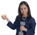the prop: Dr. Sakeena Raza holds a dumbbell and an apple, the former representing her passion for strength training, the latter her promotion of healthy, active lifestyle choices among her elderly patients.  / PBN PHOTO/MIKE SKORSKI