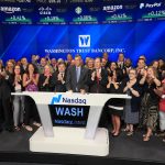 A GROUP OF EMPLOYEES from Westerly-based Washington Trust Bancorp, led by Chairman and CEO Edward O. Handy III (center), ring the opening bell Tuesday for the Nasdaq Stock Market in New York. / COURTESY NASDAQ AND WASHINGTON TRUST