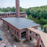 TAKE THEM TO THE RIVER: Pontiac Mills in Warwick is a sprawling former Fruit of the Loom mill complex across from Warwick Mall that is being redeveloped along the Pawtuxet River into residential and commercial space.  / PBN PHOTO/MICHAEL SALERNO