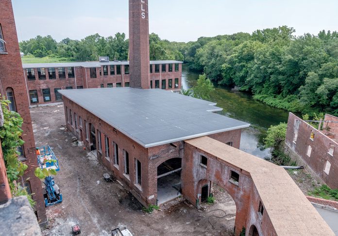 TAKE THEM TO THE RIVER: Pontiac Mills in Warwick is a sprawling former Fruit of the Loom mill complex across from Warwick Mall that is being redeveloped along the Pawtuxet River into residential and commercial space.  / PBN PHOTO/MICHAEL SALERNO