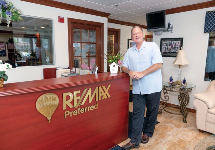 FROM AGENT TO OWNER: Richard Zompa is the owner of four RE/MAX locations in Rhode Island. He is pictured at the North Providence office, which he purchased in 1992.  / PBN PHOTO/MICHAEL SALERNO