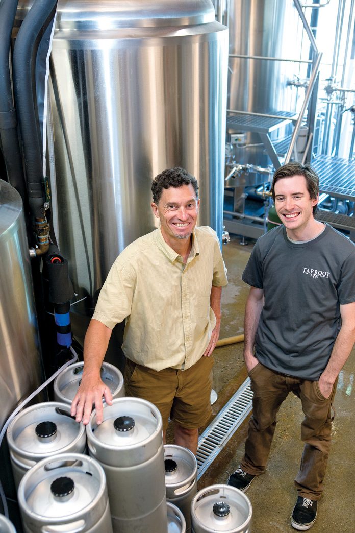 DIFFERENT TASTES: Taproot Brewing Co. owner John Nunes, left, with head brewer Kevin Beachem. The Middletown company is a subsidiary of Newport Vineyards. / PBN PHOTO/KATE WHITNEY LUCEY