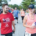 WELLNESS WARRRIORS: Kenny Boucher, left, a supervisor in the CBIZ audit department, and Danielle Poyant, director in the tax department, both members of the 15-person Road Warriors, runners from the Boston and Providence offices, compete in the Blessing of the Fleet 10-mile race in Narragansett July 27.   / PBN PHOTO/RUPERT WHITELEY