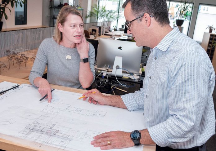PROPERTY PLANS: Christine M. West, principal at KITE Architects in Providence, looks at some residential plans for a property in Exeter with Albert Garcia, principal.  / PBN PHOTO/MICHAEL SALERNO