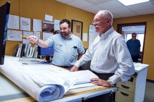 MORE COMMUNICATION: Estimator Bob Dandeneau, left, talks with Edward W. Burman Jr., president of general contractor E.W. Burman in Warwick. Burman says he would like to see more communication from the state to help ease the frequent and “challenging” filing process, such as for building and fire permits.  / PBN FILE PHOTO/RUPERT WHITELEY