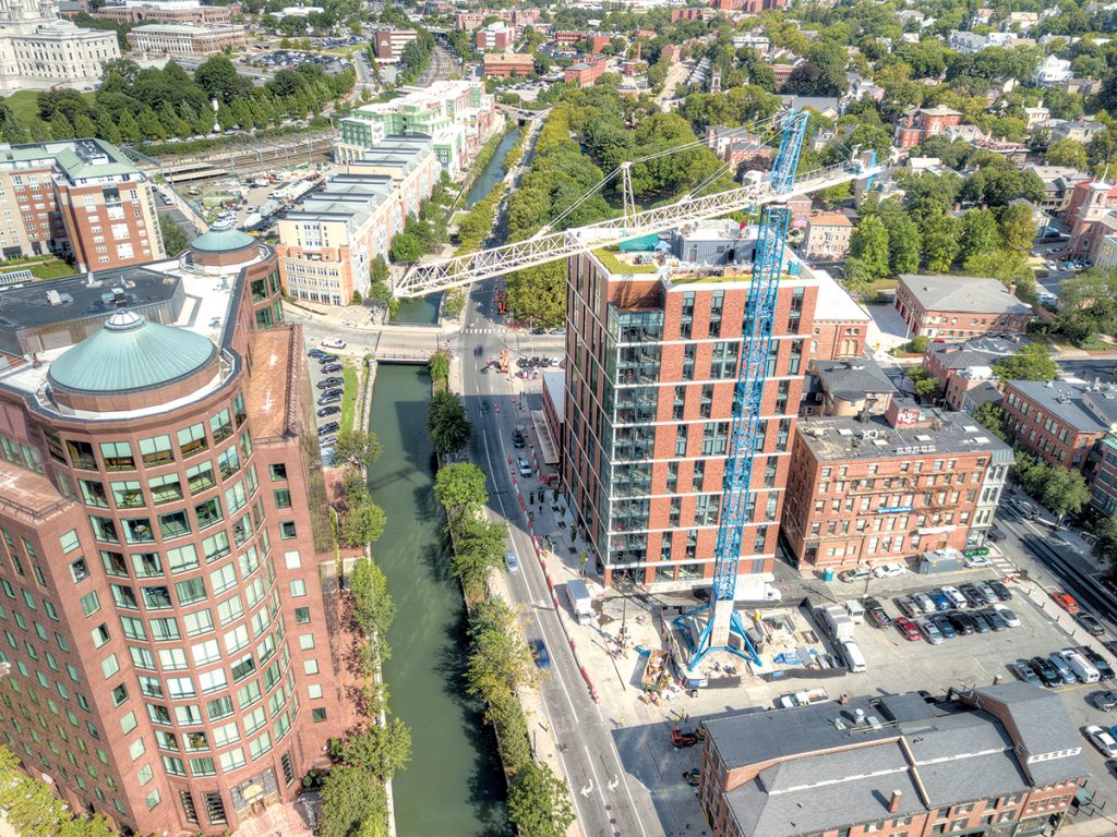 REDUCED ROLE: Although cranes are in the sky and construction projects are happening in Providence – pictured above are the nearly $57 million The Edge, foreground, and the $54 million The Commons at Providence Station, top center – Senate President Dominick J. Ruggerio Jr. said the city is getting in the way of economic development and has vowed to file a revision in the next legislative session that would speed up the review of projects locating in the Interstate 195 district by implementing changes that would reduce city government’s role in the approval process. / PBN PHOTO/PAMELA BHATIA 