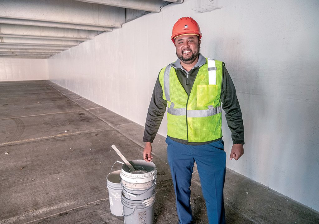 GRAFFITI REMOVAL: Jhonny Leyva, owner of Heroica Construction in Providence, was subcontracted to do the graffiti removal and painting of the parking garage on Main Street in Pawtucket.  / PBN PHOTO/MICHAEL SALERNO