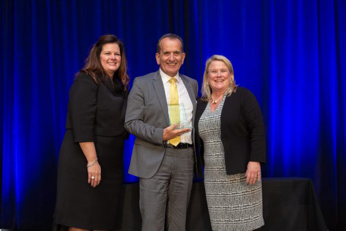 KIMBERLY GREENE (left), chairman of the board of the Providence Warwick Convention & Visitors Bureau and Martha Sheridan, PWCVB president and CEO, congratulate Larry Lepore, general manager of the Dunkin’ Donuts Center and the RI Convention Center. Lepore was inducted into the PWCVB’s Hall of Fame at its annual meeting. / COURTESY PROVIDENCE WARWICK CONVENTION AND VISITORS BUREAU