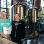 NEW PATH: Co-owners Kris Waugh, left, and Tamara McKenney worked in technical recruiting before opening Apponaug Brewing at the Pontiac Mills in Warwick. / PBN PHOTO/MICHAEL SALERNO