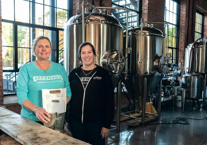 NEW PATH: Co-owners Kris Waugh, left, and Tamara McKenney worked in technical recruiting before opening Apponaug Brewing at the Pontiac Mills in Warwick. / PBN PHOTO/MICHAEL SALERNO
