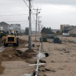 THE R.I. DIVISION of Statewide Planning is leading a project to support small businesses' ability to survive extreme weather events. Above, a machine clears sand off Atlantic Avenue in Westerly after Hurricane Sandy. / PBN FILE PHOTO/BRIAN MCDONALD