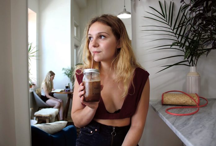 STEEL STRAWS: Brooke Finocchiaro is seated at The Nitro Bar in Providence that is owned and operated by her sister Audrey Finocchiaro. After working there for three months and being fed up with how much plastic gets used and then becomes litter, Brooke Finocchiaro started Stop Sucking RI, which sells stainless steel straws. / COURTESY STOP SUCKING RI/ALEX BRENNAN