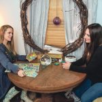 PSYCHIC READING: Roxanne Jasparro, left, owner of Bewitched of Scituate, a psychic reading and merchandise shop, does a reading for Trisha Wagner of Scituate.  / PBN PHOTO/MICHAEL SALERNO