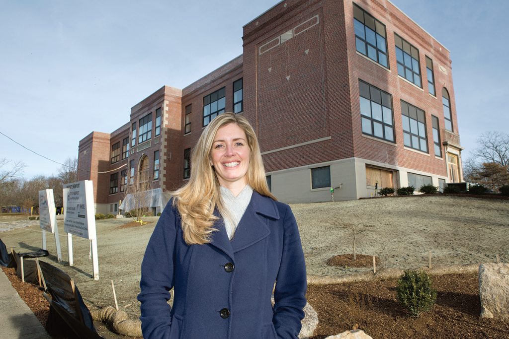 NEW OFFICE: Erin Donovan-Boyle, executive director of the Newport County Chamber of Commerce, said the Chamber’s move from Middletown to Innovate Newport won’t change its focus, but it will reach out more to the types of small tech firms and startups that would visit or do business at the business incubator. Donovan-Boyle stands in front of the former Sheffield School
building, which is being renovated and
will serve as the incubator space.
/ PBN PHOTO/KATE WHITNEY LUCEY