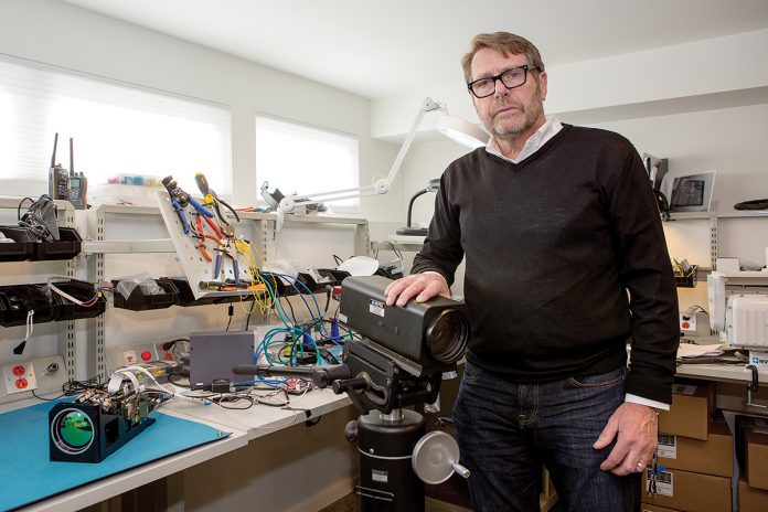 SURVEILLANCE TECH: Joe Janson, founder, owner and CEO of NVTS Night Vision Technology Solutions in Jamestown, in his design and integration testing lab with components to be integrated into a large camera system.
/ PBN PHOTO/KATE WHITNEY LUCEY SURVEILLANCE TECH: Joe Janson, founder, owner and CEO of NVTS Night Vision Technology Solutions in Jamestown, in his design and integration testing lab with components to be integrated into a large camera system.
/ PBN PHOTO/KATE WHITNEY LUCEY