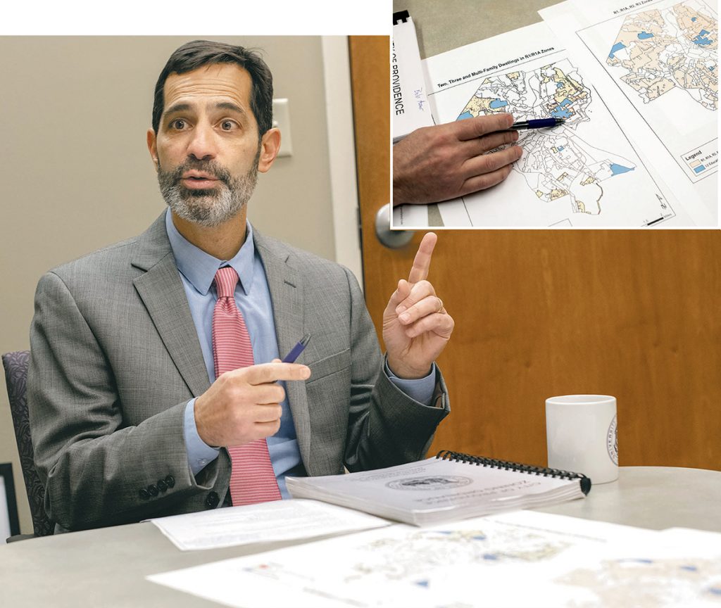 REGULATION GAPS: Bob Azar, deputy director of planning and development for Providence, points out on a few maps where the current city regulation of three students per single-family house in a single-family zone has gaps.  / PBN PHOTOS/MICHAEL SALERNO