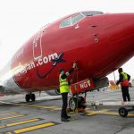NORWEGIAN AIR recently announced that it is closing its pilot and cabin-crew base at T.F. Green Airport as part of broader, worldwide cost-cutting measures. / BLOOMBERG NEWS FILE PHOTO/SIMON DAWSON
