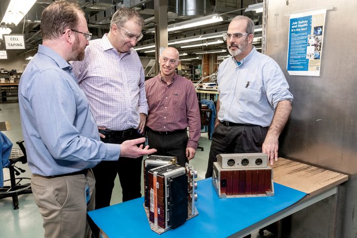 POWERFUL BATTERIES: EaglePicher Technologies in East Greenwich develops batteries for spacecraft and military jets. From left, Robert Gitzendanner, applications engineering director; George Cintra, vice president of research and development; Alex Buonanno, program manager; and Frank Puglia, director of research and development.   / PBN PHOTO/MICHAEL SALERNO