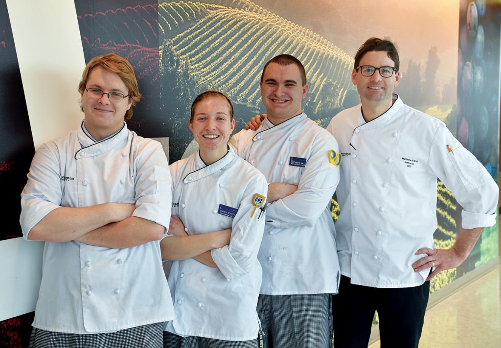 CULINARY TEAM: Johnson & Wales University culinary students, from left, Jake Vincent, Brandy Schroth and Matthew Hall, with JWU faculty chef and instructor Matthew Britt, created the Essex fried clams on the Legends menu at TD Garden in Boston.   / COURTESY JOHNSON & WALES UNIVERSITY