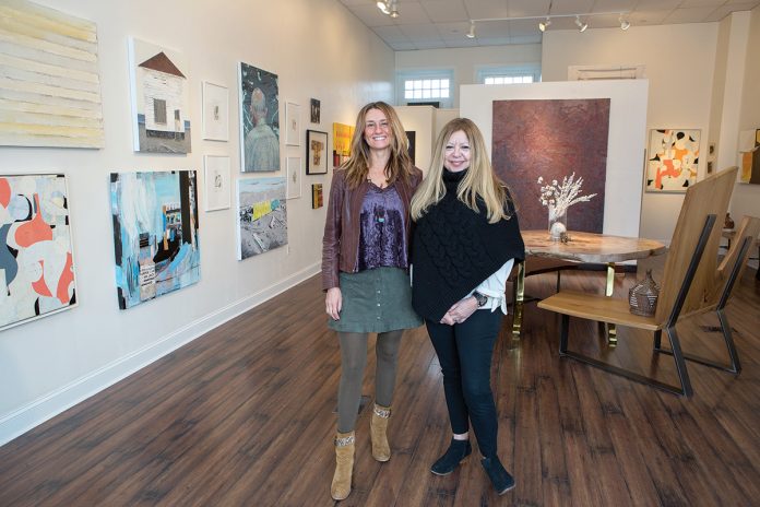 CONTEMPORARY VIEW: Bobbie Lemmons, right, founder and creative director of Atelier Newport, in the gallery with ­Michele Maker Palmieri. Lemmons focuses on emerging and midcareer artists.  / PBN FILE PHOTO/KATE WHITNEY LUCEY