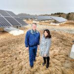 GREEN ENERGY: David Lamb, assistant director of utilities management at the University of Rhode Island, and Marcia Garcia, URI’s sustainability officer, stand among a field of solar panels in South Kingstown. The solar array is part of the 40-megawatt South Kingstown Solar Collaboration facility, of which URI is one of three partners.   / PBN PHOTO/BRIAN MCDONALD