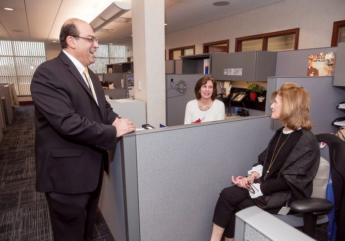 BUCKING THE TREND: Brian A. Azar, senior vice president and chief lending officer at Navigant Credit Union, speaks with Deborah Drechnowicz, center, mortgage underwriting supervisor, and Lisa Grimo, mortgage loan underwriter. Unlike most banks, which saw their mortgage loan volume go down, Navigant reported an 8 percent increase from 2017 to 2018.  / PBN PHOTO/MICHAEL SALERNO