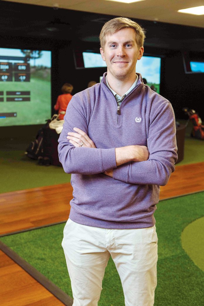 AVID GOLFER: Max Buerman is the owner of Newport Indoor Golf, a golfing facility in Portsmouth that features four virtual-reality bays with high-definition projection screens allowing golfers to play courses from around the world.
/ PBN PHOTO/RUPERT WHITELEY AVID GOLFER: Max Buerman is the owner of Newport Indoor Golf, a golfing facility in Portsmouth that features four virtual-reality bays with high-definition projection screens allowing golfers to play courses from around the world.
/ PBN PHOTO/RUPERT WHITELEY