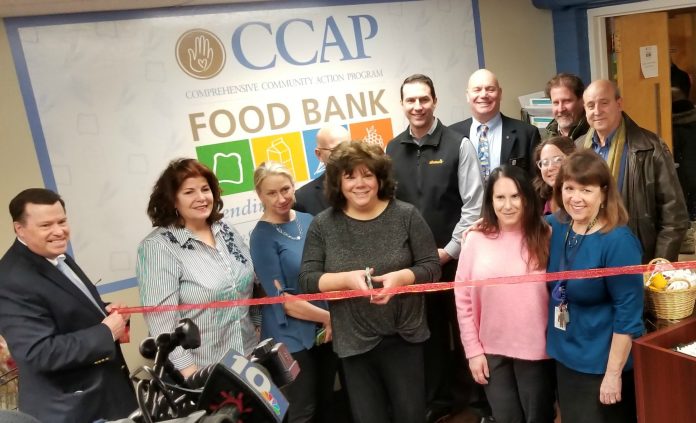 COMPREHENSIVE COMMUNITY ACTION Program staffers, Rotary Club of Cranston members and a representative of Shaw's Supermarket gather Tuesday to cut the ribbon on CCAP's newly expanded food bank at the nonprofit's office in Cranston. / COURTESY COMPREHENSIVE COMMUNITY ACTION PROGRAM