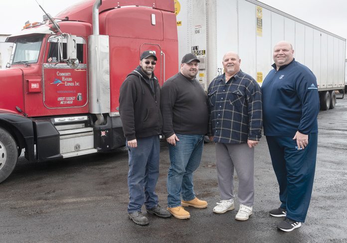 FAMILY TRUCKERS: Commodity Haulers Express is a regional truckload transportation company based at Quonset Business Park. From left, Dan Izzi, James Izzi Jr., their dad, James Izzi, and his brother Robert P. Izzi, the business’s founder and owner.  / PBN PHOTO/MICHAEL SALERNO