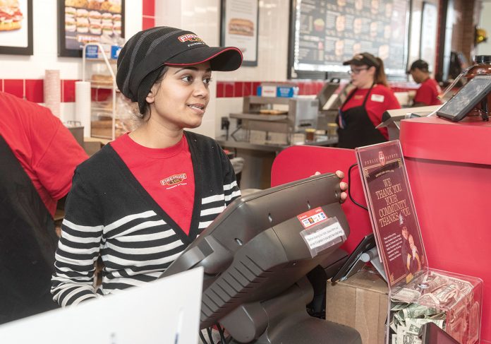 RAPID RESPONSE: Sejal Patel, foreground, co-owns the new Firehouse Subs franchise in Cranston. She’s pictured with Alicia Martinelli, shift leader, and Sovannara Keo, crew member, in the background. The business collects donations for grants awarded to police and fire departments.
/ PBN PHOTO/MICHAEL SALERNO RAPID RESPONSE: Sejal Patel, foreground, co-owns the new Firehouse Subs franchise in Cranston. She’s pictured with Alicia Martinelli, shift leader, and Sovannara Keo, crew member, in the background. The business collects donations for grants awarded to police and fire departments.
/ PBN PHOTO/MICHAEL SALERNO