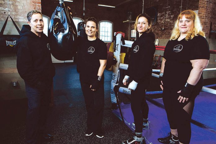 PERSONAL TRAINING: From left, Kathy Lyons, Amy Cham, Jaime Hayes and Tracy Lombard opened On the Ropes Boxing and Fitness in January in a former garage building at Pontiac Mills in Warwick, where they offer drop-in classes, regular classes and personalized fitness.
/ PBN PHOTO/RUPERT WHITELEY PERSONAL TRAINING: From left, Kathy Lyons, Amy Cham, Jaime Hayes and Tracy Lombard opened On the Ropes Boxing and Fitness in January in a former garage building at Pontiac Mills in Warwick, where they offer drop-in classes, regular classes and personalized fitness.
/ PBN PHOTO/RUPERT WHITELEY