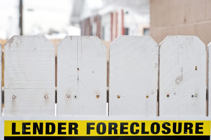 MORTGAGE DELINQUENCY in Rhode Island declined 1.1 percentage points year over year to 4.7 percent in December. / BLOOMBERG NEWS FILE PHOTO/DAVID CALVERT