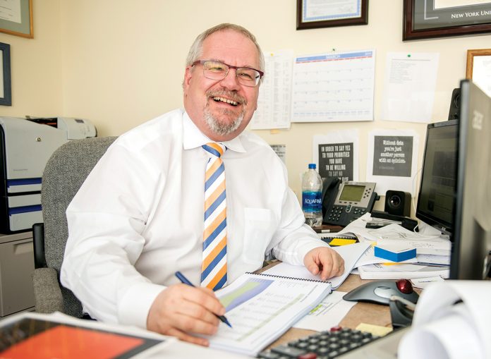 NUMBERS CRUNCHER: North Kingstown Finance Director James Lathrop has developed more-readable financial reports and annual budgets to encourage more engagement from town residents.   / PBN PHOTO/DAVE HANSEN