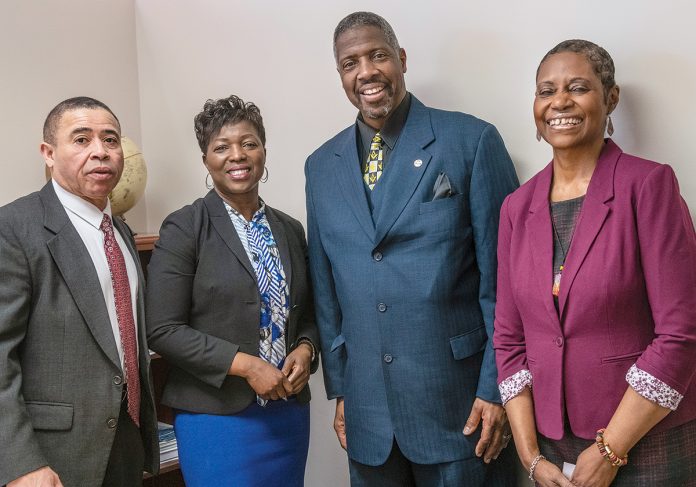 SHOWING UP: Rhode Island Black Business Association President Lisa Ranglin meets with members at the office. From left: Retired R.I. State Police Lt. John P. A’Vant; Ranglin; Clarence R. Sneed Jr., CEO of S&S Trucking; and Donna M. Sams, Community College of Rhode Island campus coordinator, Providence and Lincoln.  / PBN PHOTO/MICHAEL SALERNO