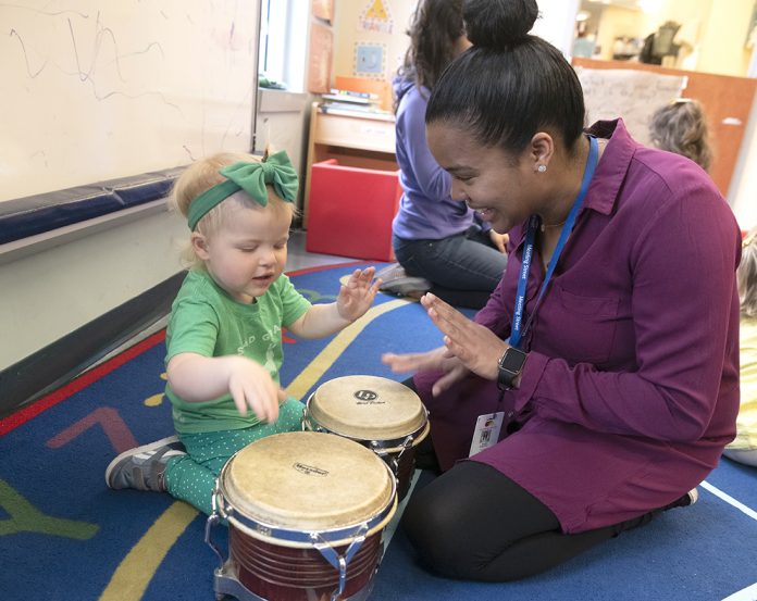 PERCUSSION SKILLS: Meeting Street teacher’s assistant Ruth Espinal, right, practices percussion skills with Cameron Cuddy at the Early Learning Center.  / PBN PHOTO/MICHAEL SALERNO