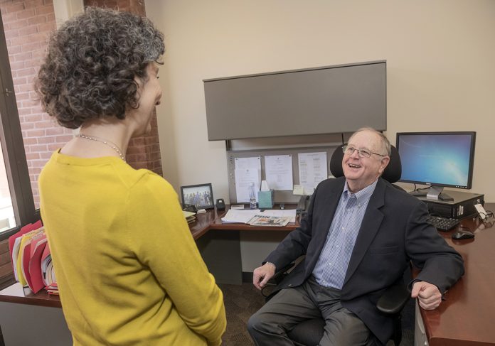BUSINESS EXPANSION: Thomas Hoagland, executive director of the Providence Business Loan Fund, speaks with Kathy Cosentino, assistant director for business development.   / PBN PHOTO/MICHAEL SALERNO