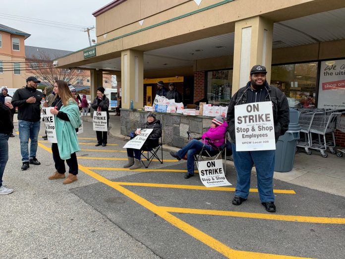 UNIONIZED WORKERS picket outside of East Side Market, a Stop & Shop-owned grocery store closed down due to the strike, More than 31,000 workers are striking in New England following an impasse in contract negotiations. / PBN PHOTO/MARY MACDONALD