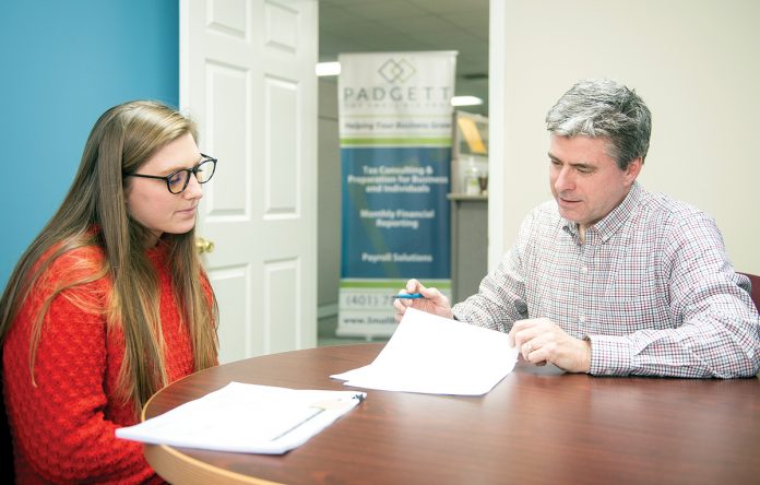 FINANCIAL PLANNING: Jeffrey Kreyssig, owner of Padgett Business Services, meets with client Abbey Dyer, office manager for Narragansett Property Management, in his Narragansett office.  / PBN PHOTO/DAVE HANSEN 