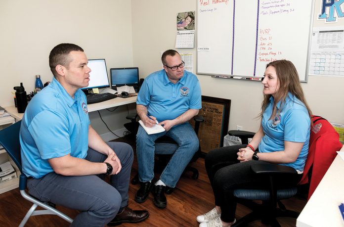 MAKING CONNECTIONS: Tyrone A. Smith, left, director of employment and housing at Operation Stand Down Rhode Island, meets with Tim Ruel, veterans employment and training specialist, and Lindsey Arigno, veterans employment specialist. OSDRI assists veterans who are seeking jobs.  / PBN PHOTO/MICHAEL SALERNO