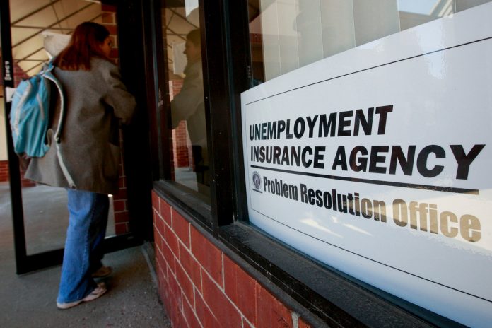US. JOBLESS claims remained unchanged at 230,000 last week . / BLOOMBERG NEWS FILE PHOTO/JEFF KOWALSKY