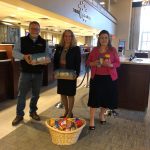 FROM LEFT TO RIGHT, PHIL MASON of ServiceMaster by Mason; Elizabeth Eckel, chief marketing officer for The Washington Trust Co.; and Beth Markowski-Roop of ServiceMaster by Mason pose with donated peanut butter at Washington Trust's Westerly Branch as ServiceMaster by Mason delivers boxes of peanut butter to Washington Trust's 19th annual Peanut Butter Drive. / COURTESY THE WASHINGTON TRUST CO.