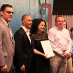 ELIZABETH AMADIO, a sixth-grade teacher at Gilbert Stuart Middle School, was named the 2019 Providence Public Schools District Teacher of the Year. Above, from left, Tom Flanagan, chief academic office for PPSD, Providence Mayor Jorge O. Elorza, Elizabeth Amadio and Amadio's husband Johm. / COURTESY CITY OF PROVIDENCE