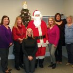 IN THE SPIRIT: Members of the Carey, Richmond & Viking staff mark the holidays with a visit from Santa.  / COURTESY CAREY, RICHMOND & VIKING INSURANCE