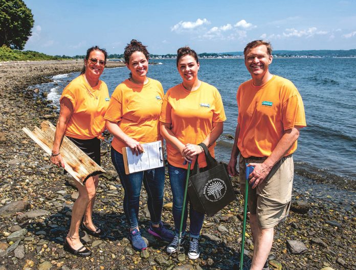 PRETTY NEAT: Amica employees use their annual volunteer day to work with Clean Ocean Access to clear debris from the local shoreline.  / COURTESY AMICA MUTUAL INSURANCE