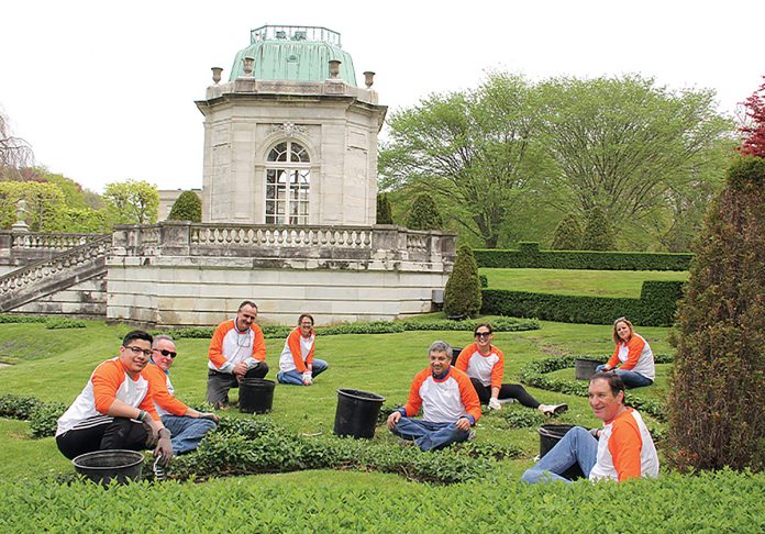 LOOKING SPIFFY: Embrace employees volunteer to beautify Newport Preservation Society properties ahead of the tourism season.  / COURTESY EMBRACE HOME LOANS