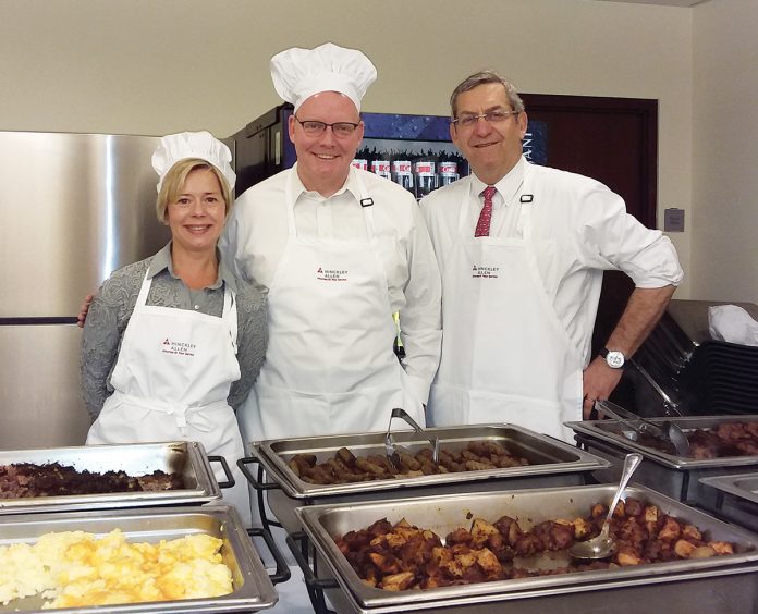 SWITCHING UP: From left, attorneys Robin L. Main, Todd M. Gleason and David J. Rubin serve food on Administrative Professionals Appreciation Day.  / COURTESY HINCKLEY, ALLEN & SNYDER