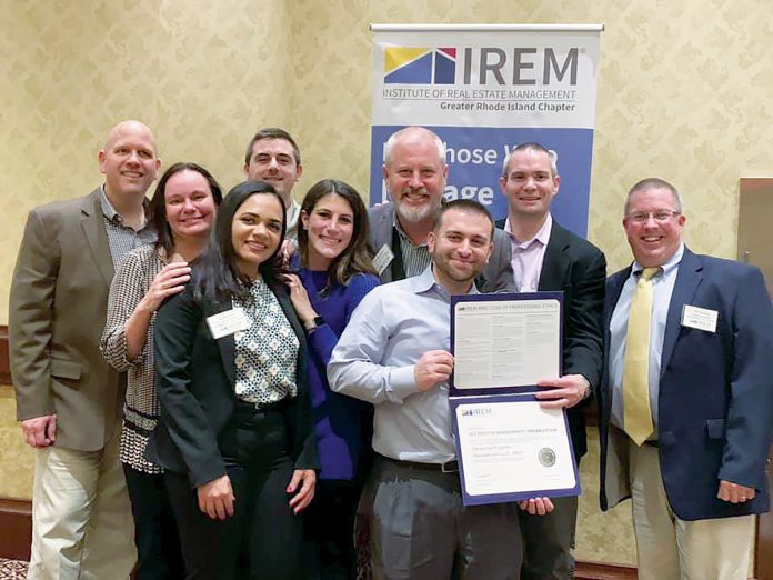 HAPPY BUNCH: Peregrine employees proudly display the Accredited Management Organization designation they earned in December.  / COURTESY PEREGRINE PROPERTY MANAGEMENT