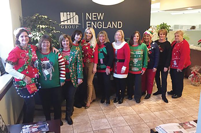 MODEL EMPLOYEES: Staff members at The Hilb Group of New England show off their gaudy holiday sweaters.  / COURTESY THE HILB GROUP OF NEW ENGLAND